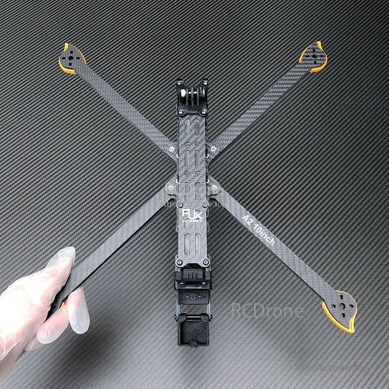 RJX A2 10-inch carbon fiber FPV drone frame kit with X arms, orange motor mount ends, and center plate