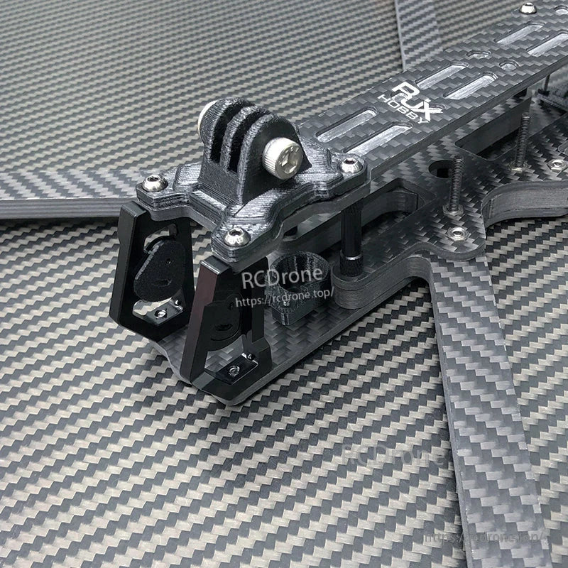 Close-up of RJX A2 carbon fiber FPV drone frame front section with camera cage and GoPro-style mount