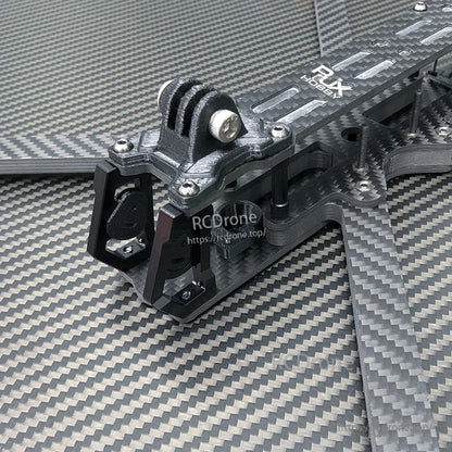 Close-up of RJX A2 carbon fiber FPV drone frame front section with camera cage and GoPro-style mount