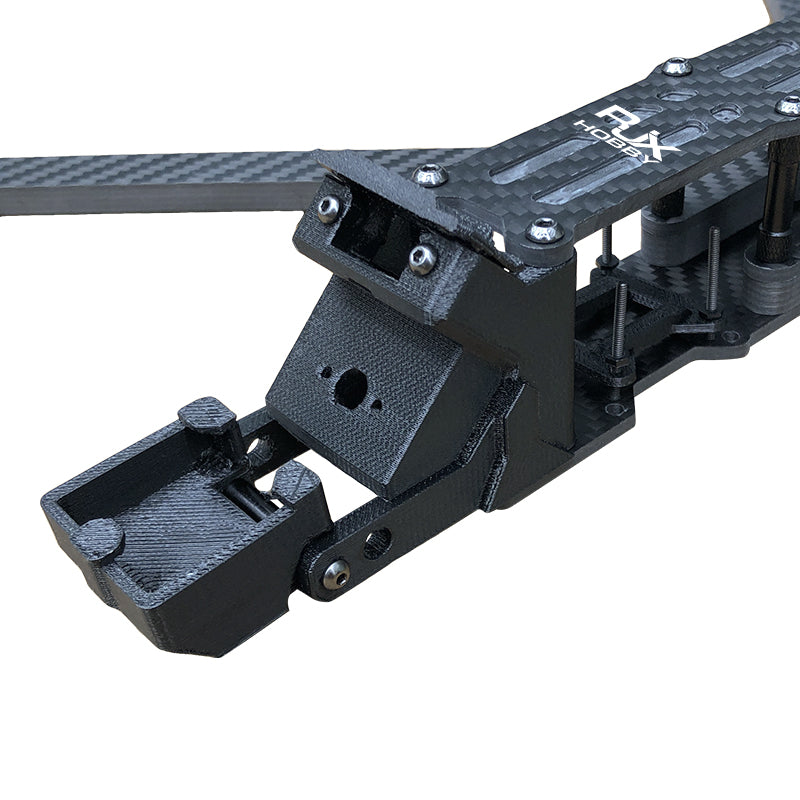 Close-up of RJX A2 carbon fiber FPV drone frame front section with camera mount and top plate hardware