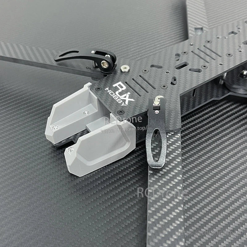 RJX Hobby carbon fiber FPV drone frame top plate with mounting slots, metal bracket and gray 3D-printed mount