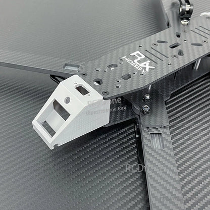 Close-up of RJX Hobbies carbon fiber FPV drone frame with front camera mount and arm hardware