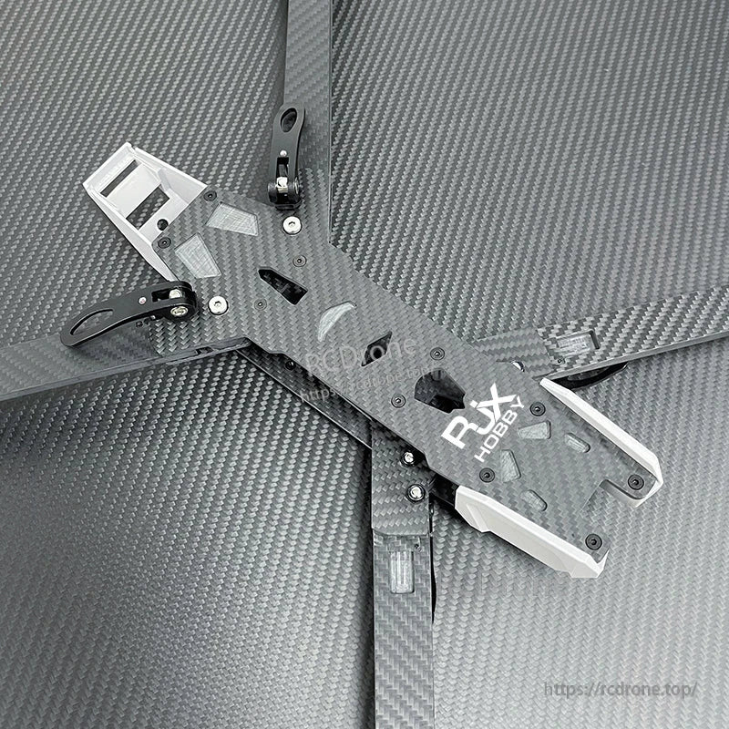 Carbon fiber FPV racing drone frame kit with DJI logo top plate, wide arms, and white 3D-printed mounts
