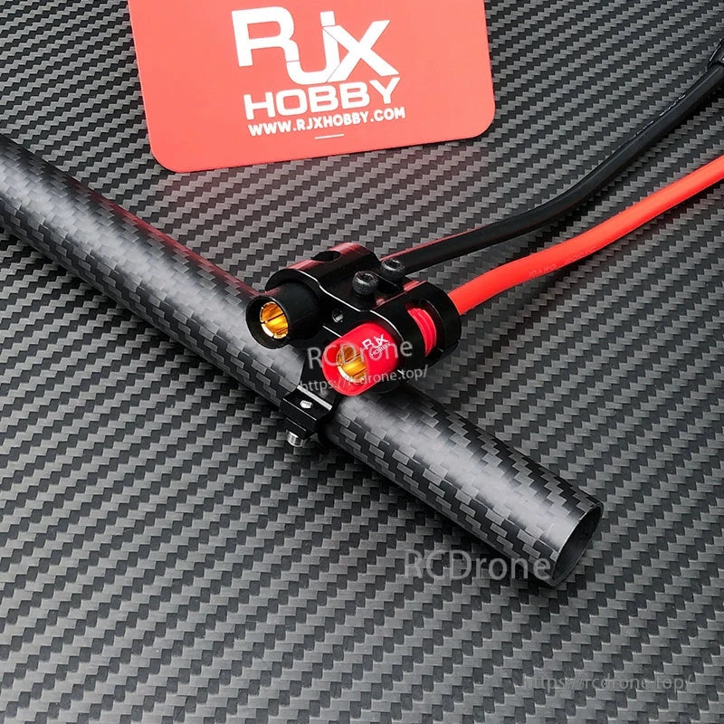 RJX AS150 Holder Mount, RJX AS150 connector holder mount clamped to a carbon fiber tube with red/black power leads and gold terminals