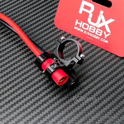 RJX AS150 holder mount with red and black AS150 battery connectors and clamp bracket on carbon-fiber surface