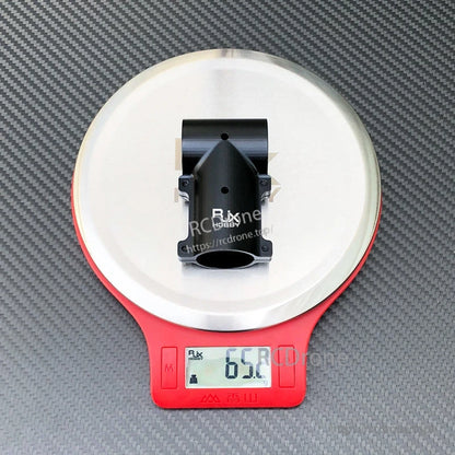 Black aluminum tee joint landing gear connector for RC drone, shown on a digital scale reading 65.2 g