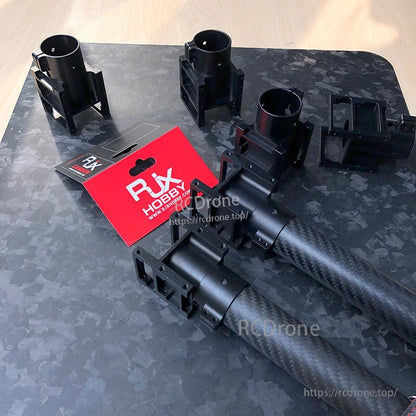 RJX aluminum alloy center plate mount holders clamped on carbon fiber tubes with RJX Hobby packaging