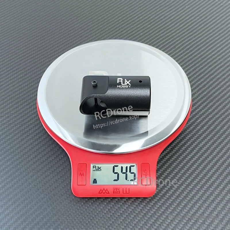 RJX Hobby metal tee landing gear tube connector clamp on digital scale, weight reading 54.5 g