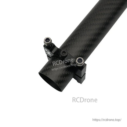 Black aluminum alloy tube clamp bracket with two mounting lugs fitted on a carbon fiber drone pipe