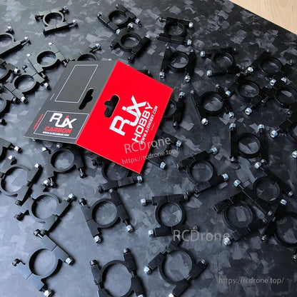 RJX anodized aluminum tube pipe clamps with mounting screws spread out next to RJX Hobby retail packaging