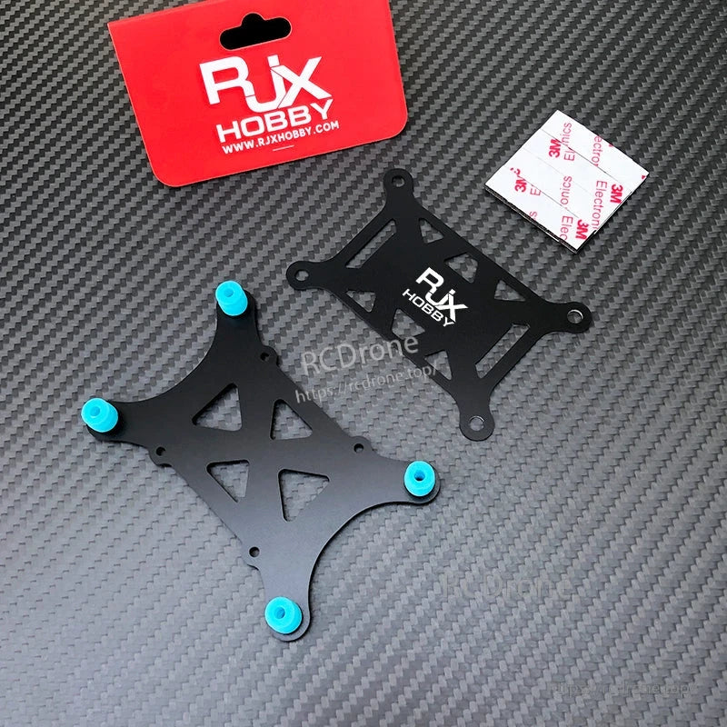 RJX anti-vibration flight controller mount kit with two black plates, blue rubber dampers, and 3M adhesive pads