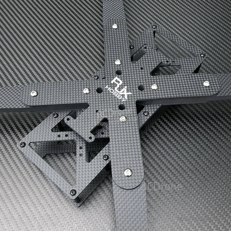 Top view of RJX carbon fiber RC FPV drone frame kit with cross arms, mounting holes, and hardware.
