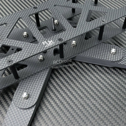 Close-up of RJX Hobby carbon fiber RC drone frame plates with standoffs and mounting hardware