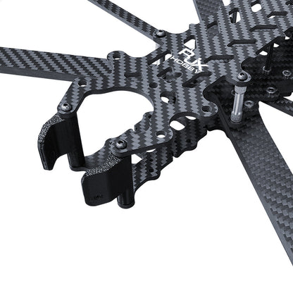Close-up of carbon fiber FPV drone frame kit top plate with arm mounts, standoffs, and front TPU camera mount