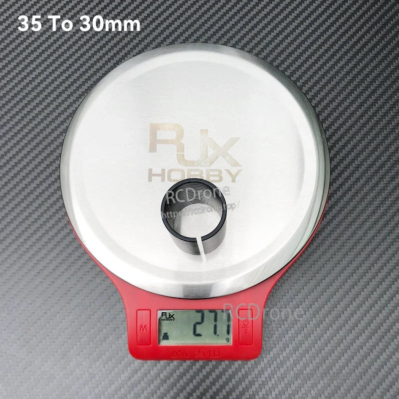 RJX 35 to 30mm diameter-changing adapter sleeve on a digital scale reading 27.7g