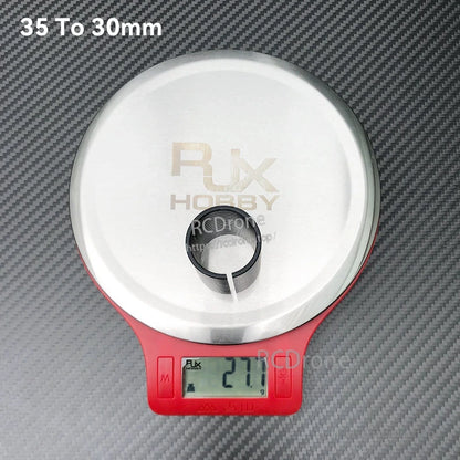 RJX 35 to 30mm diameter-changing adapter sleeve on a digital scale reading 27.7g
