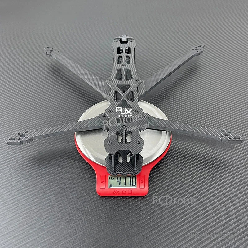 RJX GK carbon fiber FPV racing drone frame on a digital scale, displaying a 417.0 g weight reading