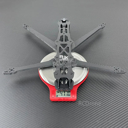 RJX GK carbon fiber FPV racing drone frame on a digital scale, displaying a 417.0 g weight reading