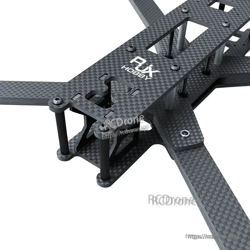 Close-up of RJX LK carbon fiber FPV racing drone frame with four arms, top plate, and standoffs