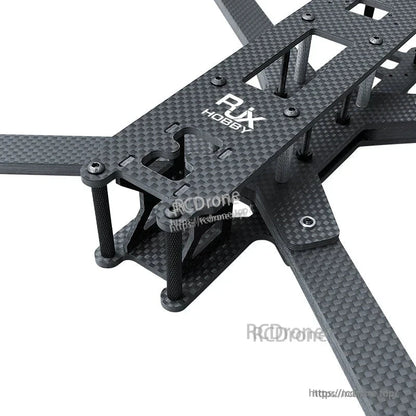 Close-up of RJX LK carbon fiber FPV racing drone frame with four arms, top plate, and standoffs