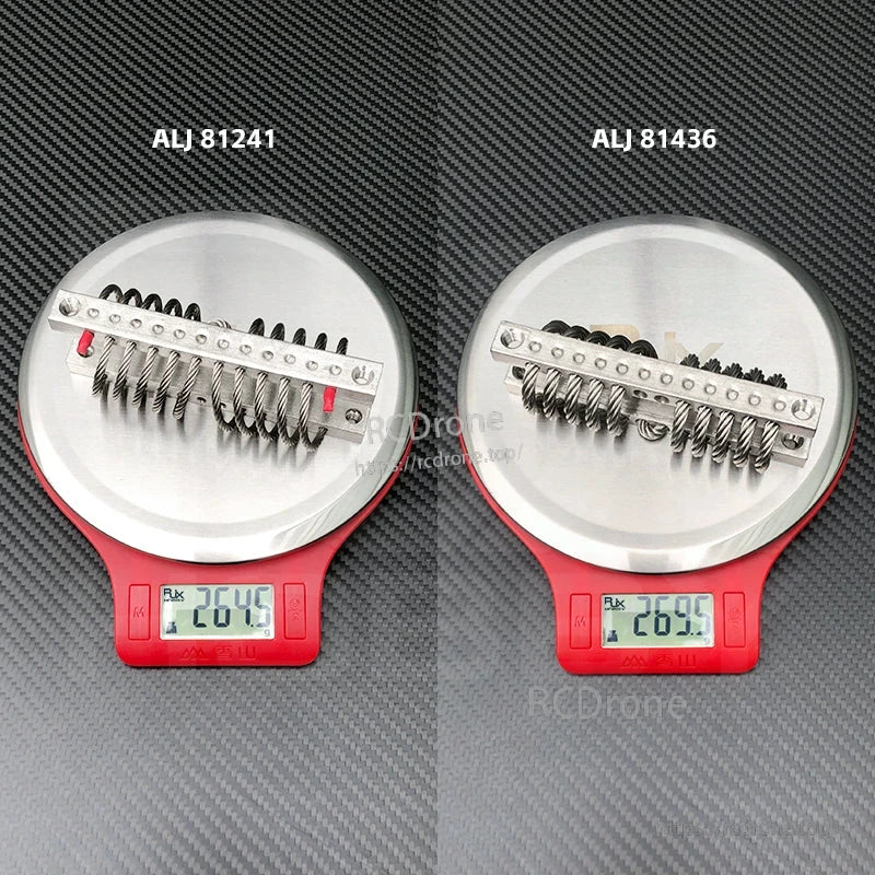 RJX steel wire rope vibration isolator with metal mounting bar on a digital scale, showing about 26.5–27 g weight