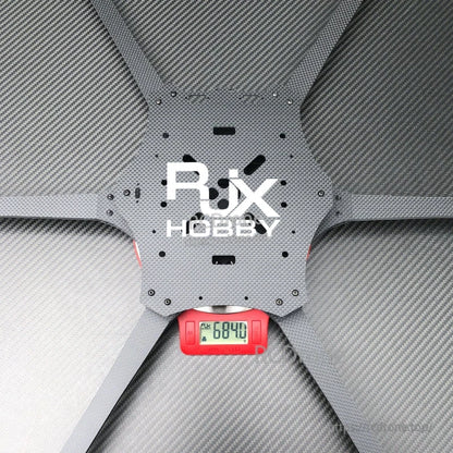 RJX Hobby carbon fiber 6-arm FPV drone frame center plate on a digital scale reading 684.0 g