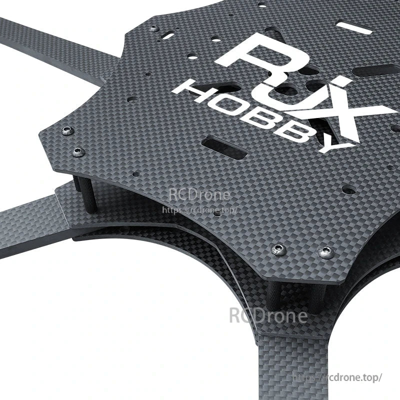Close-up of RJX Hobby carbon fiber FPV drone frame center plates with standoffs and mounting holes