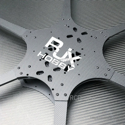 Close-up of RJX Hobby carbon fiber FPV drone frame center plate with mounting holes and six arm cutouts