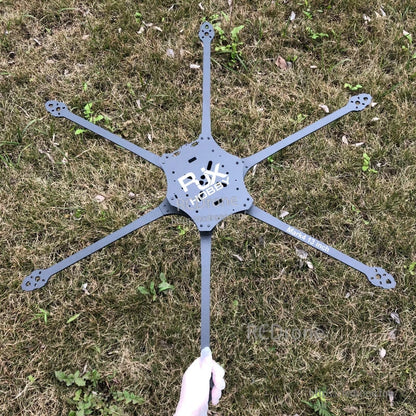 RJX Mark4 13-inch 6-arm carbon fiber FPV drone frame plate and arms laid out on grass