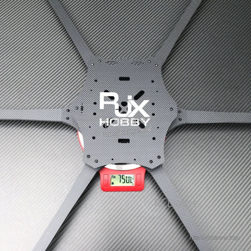 RJX Hobby Mark4 6-arm carbon fiber drone frame center plate on a scale reading 750 g