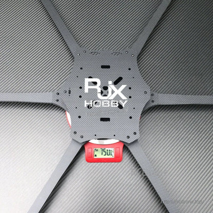 RJX Hobby Mark4 6-arm carbon fiber drone frame center plate on a scale reading 750 g