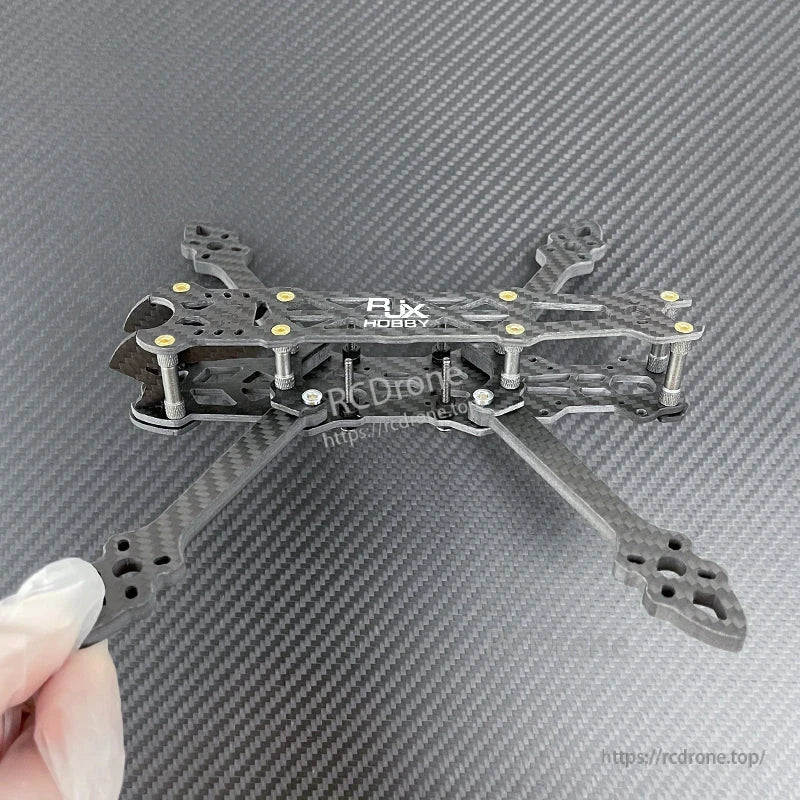 RJX carbon fiber 5-inch FPV racing drone frame kit with four arms, matte twill plates, and standoffs