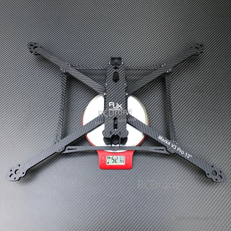 RJX Mark4 V3 Pro 13-inch carbon fiber FPV drone frame kit with X-style arms, shown on a scale reading ~520 g