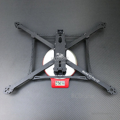 RJX Mark4 V3 Pro 13-inch carbon fiber FPV drone frame kit with X-style arms, shown on a scale reading ~520 g