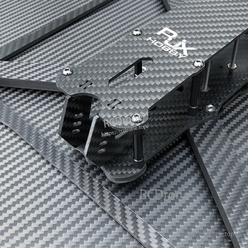 RJX Hobby carbon fiber FPV drone frame kit close-up with stacked plates, standoffs, screws, and arms