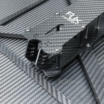 RJX Hobby carbon fiber FPV drone frame kit close-up with stacked plates, standoffs, screws, and arms