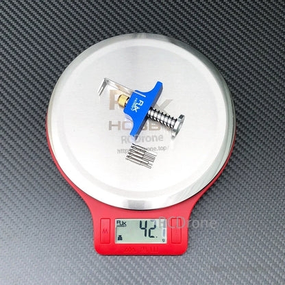 RJX propeller removal tool puller with blue handle and screw mechanism on a digital scale reading 42.1 g