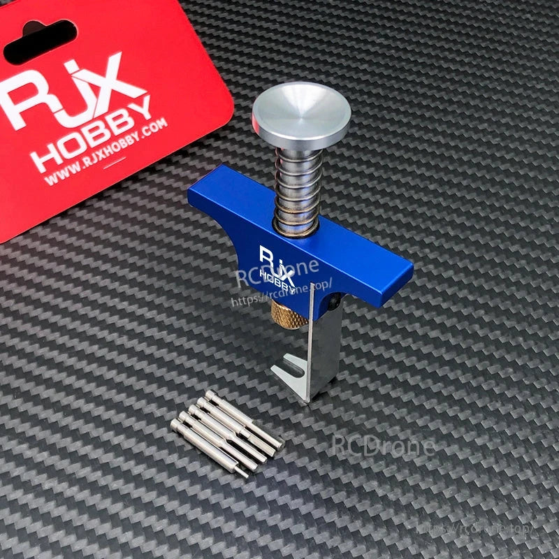 RJX Propeller Removal Tool, RJX Hobby propeller removal tool with screw press handle, metal clamp and pin set on carbon-fiber mat