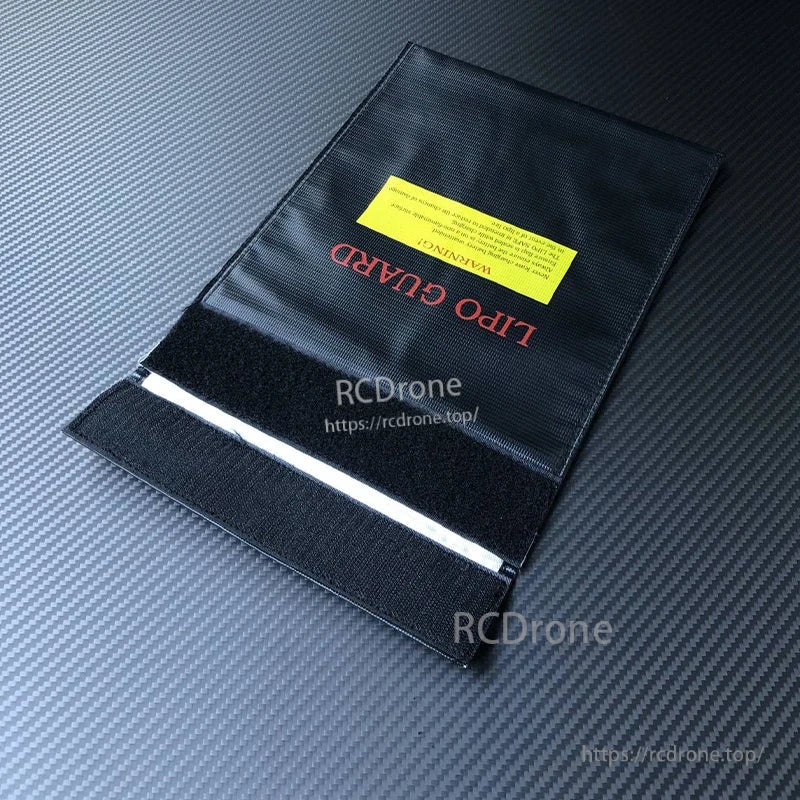 RJX RC LiPo Battery Safety Bag, Black RJX LiPo battery safety bag with Velcro flap closure and yellow warning label on top