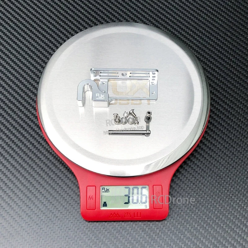 RJX servo dispenser parabolic switch metal bracket kit with linkage rod and screws on a scale reading 30.6 g