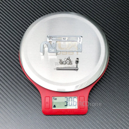 RJX servo dispenser parabolic switch metal bracket kit with linkage rod and screws on a scale reading 30.6 g