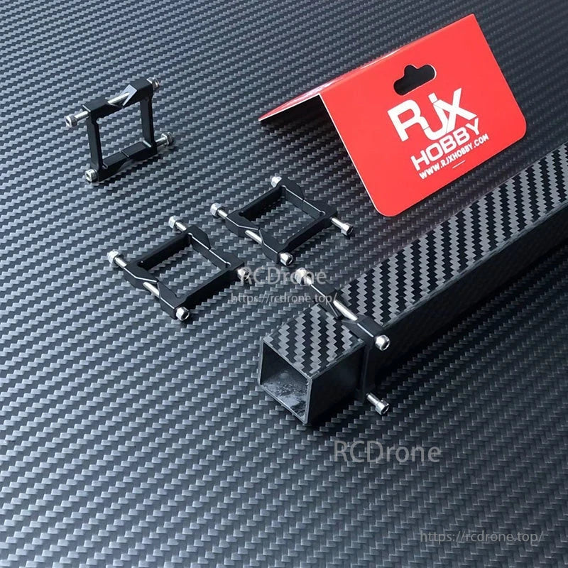 RJX Square Aluminum Tube Clamp, RJX Hobby square aluminum tube clamps with mounting screws on a carbon-fiber surface