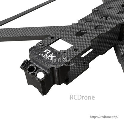 RJX X13 carbon fiber FPV drone frame section with thick arm plates and a 3D-printed front mount block