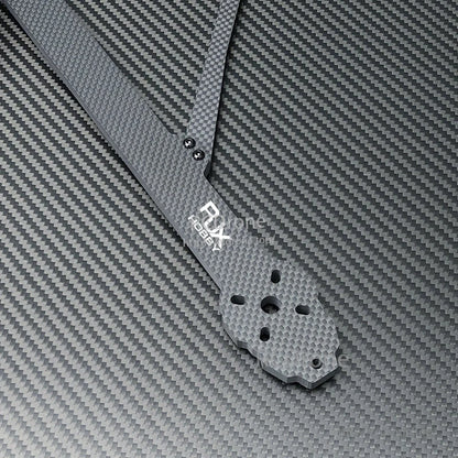 Close-up of RJX X13 carbon fiber FPV drone frame arm with motor mounting hole pattern and logo
