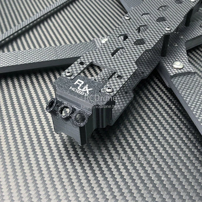 Close-up of RJX X13 carbon fiber FPV drone frame with stacked plates and front TPU mount bracket