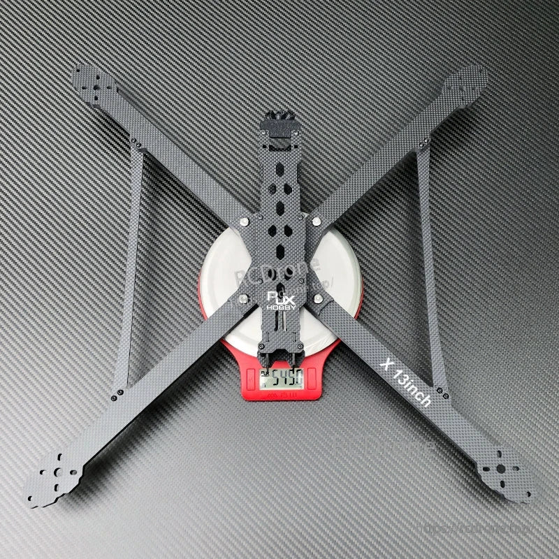 RJX X13inch carbon fiber FPV drone frame with four long arms and center plates on scale reading 254.0g