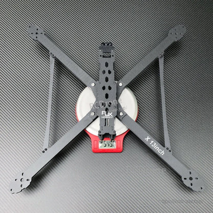 RJX X13inch carbon fiber FPV drone frame with four long arms and center plates on scale reading 254.0g