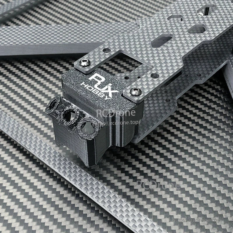 Close-up of RJX carbon fiber drone frame plate with RJX Hobby mount block and metal screws