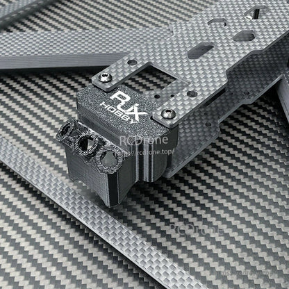 Close-up of RJX carbon fiber drone frame plate with RJX Hobby mount block and metal screws