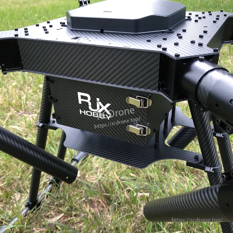 Close-up of RJX1300C carbon fiber quadcopter frame center body with latched battery compartment and landing legs